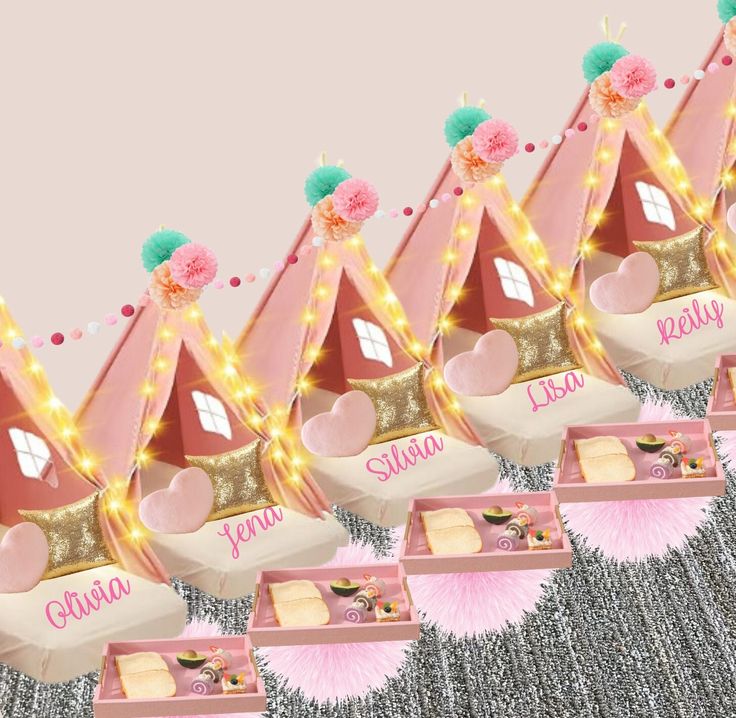 a row of pink princess themed boxes with lights on the top and bottom, all decorated in gold