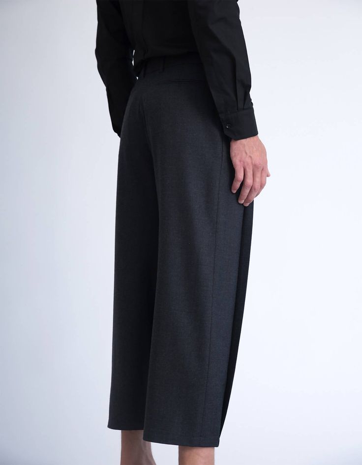 These tailored pleated pants are architectural, geometrical and crisp, yet at the same they are dynamic, full of volume and have a mesmerising movement. Pleating has been a key element in our latest collections, and all of our pleated items are treated and pleated individually. These pleated pants have front pleats that are closed at the hem, and are cropped above the ankle [full length and color options are available in the customisation section bellow]. Tailored from a soft polyester fabric, t Pleated Pants, Tailored Pants, Black Grey, Woven Fabric, Duster Coat, Polyester Fabric, Full Length, Black And Grey, Key