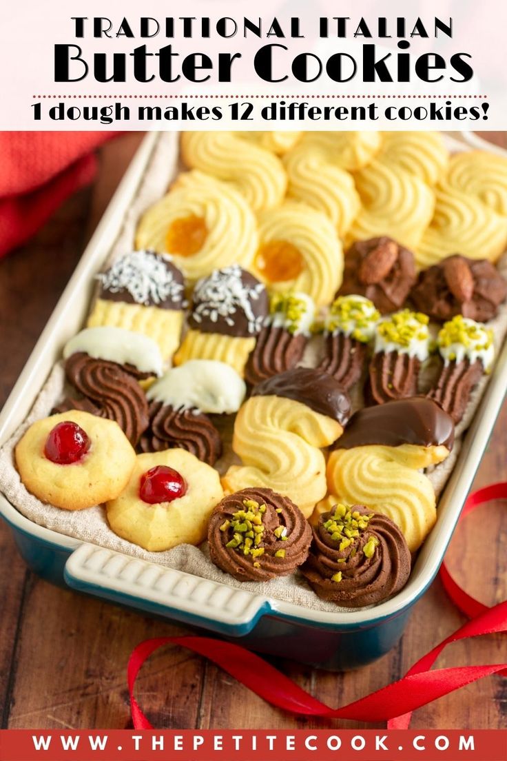 a pan filled with cookies and pastries next to a red ribbon on a wooden table