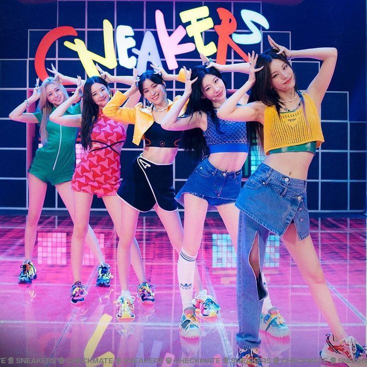 the girls are posing in front of a neon sign