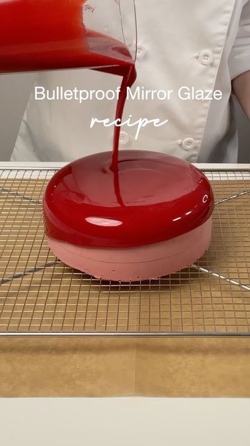 a person pouring red liquid on top of a pizza oven pan with the words bulletproof mirror glaze recipe below it