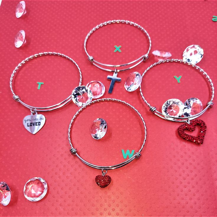 Valentine's Day  Stainless steel adjustable bangle bracelet, one is a stainless steel heart with the words 'You are so loved', one has a solid red glitter puffy heart, one has a red glitter puffy cut out heart, and one has a stainless steel cross. Adjustable Bangle Bracelet, Steel Cross, Diffuser Bracelets, Adjustable Bangle, Solid Red, Glitter Hearts, Puffy Heart, Red Glitter, Cleaning Jewelry