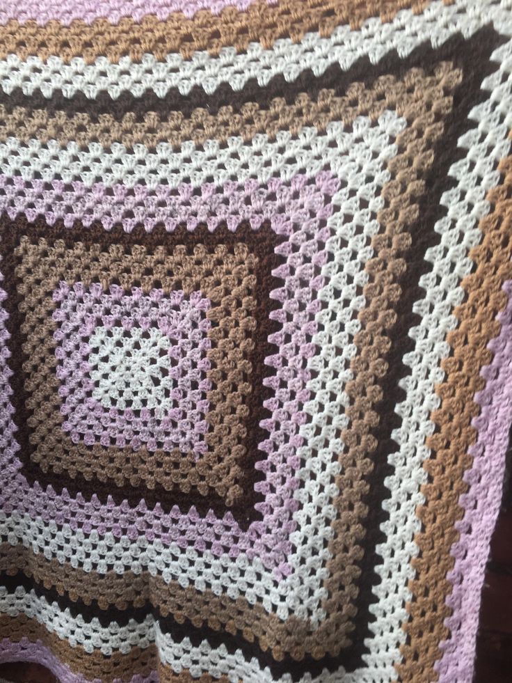 a crocheted blanket that has squares on it