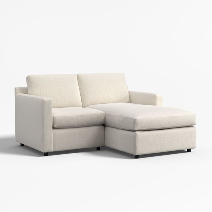 a white couch with a chaise lounger on the bottom right side and an ottoman in the middle