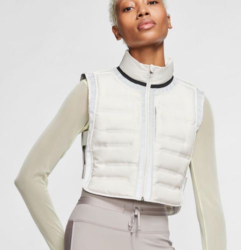 This is a great brand new with tags Nike Aeroloft running vest.  Open side quilted vest with side elastic straps.  Off white color.  $200 retail.  Guaranteed authentic