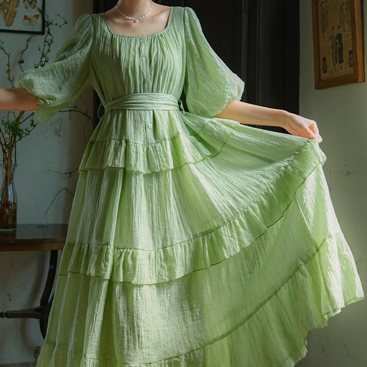 A fresh green forest that sparkles like a jewel in the sunlight. A dress with bright and refreshing colors. The sleeves are fluffy puff sleeves, and the skirt part has a tiered design that looks like layers. You will be fascinated by the way it sways softly and gracefully. 
 
 Size 
 
 S size
 
 Length: 120cm 
 
 Shoulder width: 35cm 
 Bust: 108cm 
 
 Sleeve length: 37cm 
 
 
 M size
 
 Length: 122cm 
 
 Shoulder width: 36cm 
 Bust: 112cm 
 
 Sleeve length: 38cm 
 
 
 
 
 Material 
 
 Lyocell Green Tiered Ruffle Midi Dress, Green Tiered Midi Dress With Ruffles, Green Tiered Midi Dress With Ruffle Hem, Tiered Maxi Dress With Gathered Sleeves, Green Summer Dress With Gathered Sleeves, Tiered Puff Sleeve Dress For Garden Party, Green Puff Sleeve Maxi Dress For Summer, Green Maxi Dress With Gathered Sleeves, Spring Tiered Dress With Gathered Sleeves