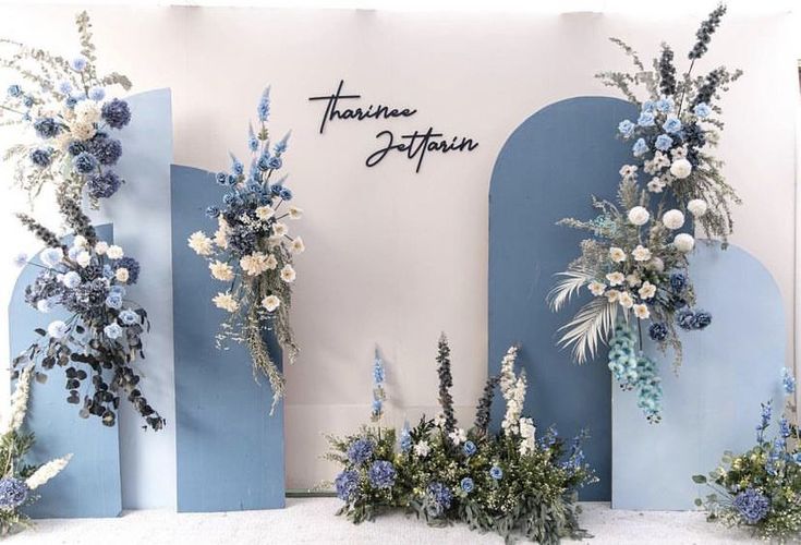 blue and white flowers are on display in front of a wall that says,'flower boutique