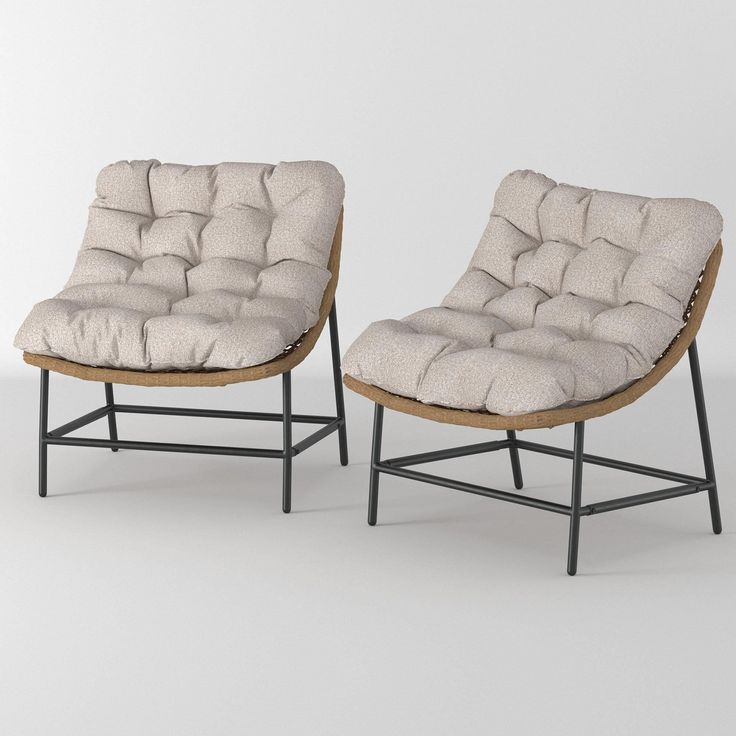 two chairs sitting next to each other on a white surface