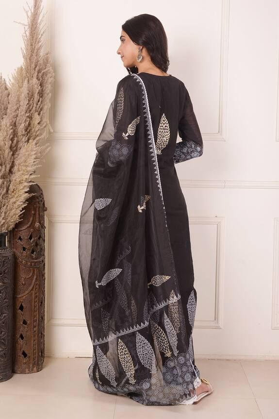 Black chanderi kurta featuring front floral block print panel highlighted with lace. Comes with palazzo and dupatta.
Components: 3
Pattern: Block Print
Type Of Work: Floral, Lace
Neckline: Notched
Sleeve Type: Three quarter
Fabric: Kurta: Chanderi, Palazzo: Cotton, Dupatta: Organza 
Color: Black
Other Details: 
Length:
Kurta:  47 Inches
Palazzo: 38 Inches
Dupatta: 2.5 Mtr 
Occasion: Sangeet,Mehendi and Haldi - Aza Fashions Black Kurta, Floral Block Print, Palazzo Set, Cotton Dupatta, Lace Neckline, Set For Women, Aza Fashion, Sleeve Type, Three Quarter