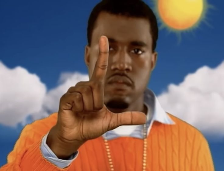 a man in an orange shirt is making the peace sign with his hand while standing against a blue sky and clouds