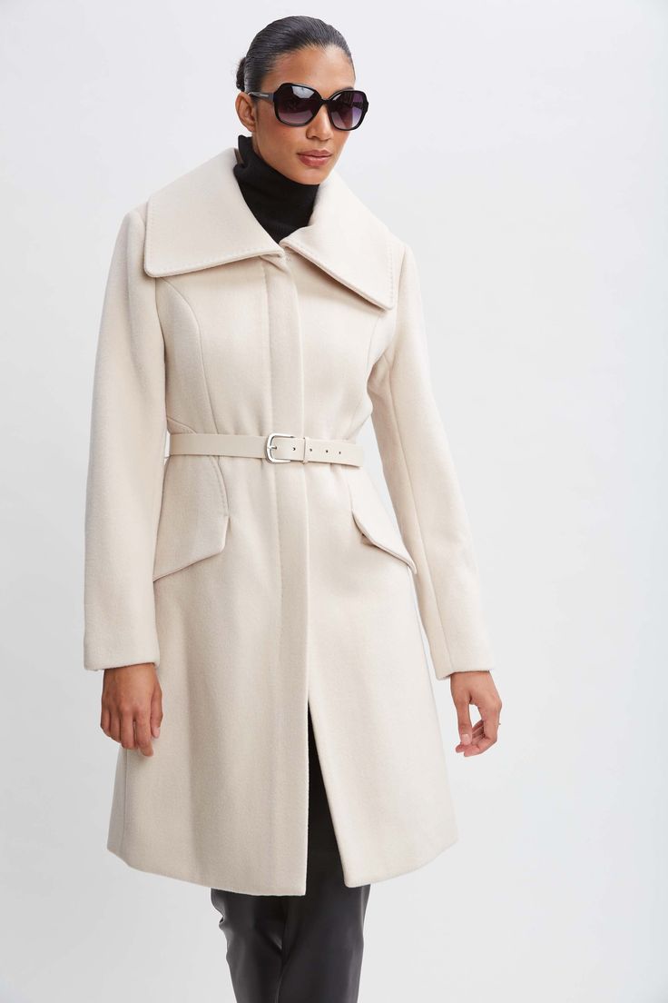 Wrap up this season in our chic belted coat done in a warm double face wool. This sophisticated fully lined coat makes a cold weather statement featuring an oversized collar, contour seams and vegan leather belt; the silhouette is a modern twist on a classic, setting a new standard in outerwear. Elie Tahari Exclusive Panel Wool Coat with Vegan Leather Belt & oversized collar 80% Wool, 15% Nylon, 5% Cashmere Runs true to Size Length From Shoulder to Hem: Back 38.5"L, Sleeve: 33"L (approx. length Fitted Long Coat With Belt, Chic Wool Coat With Belted Cuffs And Lapel Collar, Elegant Wool Coat With Belted Cuffs And Lapel Collar, Chic Belted Wool Coat With Lapel Collar, Classic Formal Outerwear With Belt Detail, Elegant Fitted Wool Coat With Belted Cuffs, Winter Belted Pea Coat With Lapel Collar, Winter Pea Coat With Belt And Lapel Collar, Winter Pea Coat With Belted Lapel Collar