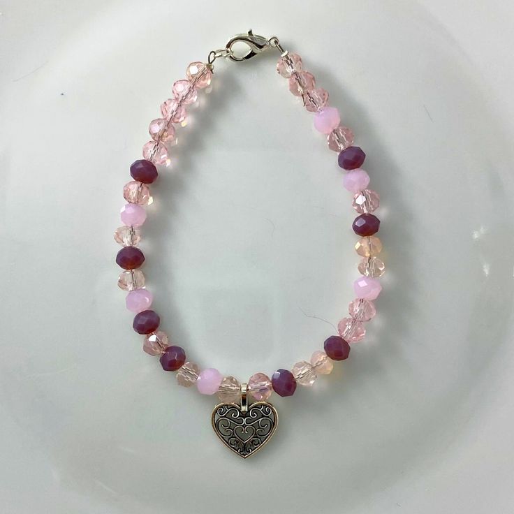 "🌸 Sign up for the Starfish by Kristan email list and get 15% off your order NOW! https://mailchi.mp/13833f6189a3/new-customers 🌸 Looking for high quality, affordable jewelry?  If so, this bracelet is for you!  This pink/clear 4mm round crystal bead bracelet with a silver heart charm. OUR BRACELETS ARE... *Made with high quality lava stones, semi-precious beads, silver, and glass beads *Tarnish free silver wire & gold wire, 925 silver, 1mm stretch cord, waxed linen cord *Crafted in house *Available in size 7.5\" CARE INSTRUCTIONS *Remove before swimming or showering *Do not use harsh chemicals  *Roll bracelet over hand, do not over stretch SHIPPING INFORMATION *Once I receive your order, I will ship out to you in the timeframe below *Orders are shipped in a padded mailer to ensure a safe Affordable Customized Pink Charm Bracelet, Bohemian Crystal Bracelet With Heart Beads, Pink Bohemian Jewelry For Valentine's Day, Bohemian Pink Jewelry For Valentine's Day, Pink Jewelry With Colorful Beads For Valentine's Day, Elegant Pink Beaded Bracelets With Heart Beads, Elegant Pink Heart Beaded Bracelets, Pink Valentine's Day Jewelry With Colorful Beads, Elegant Pink Heart-shaped Beaded Bracelets