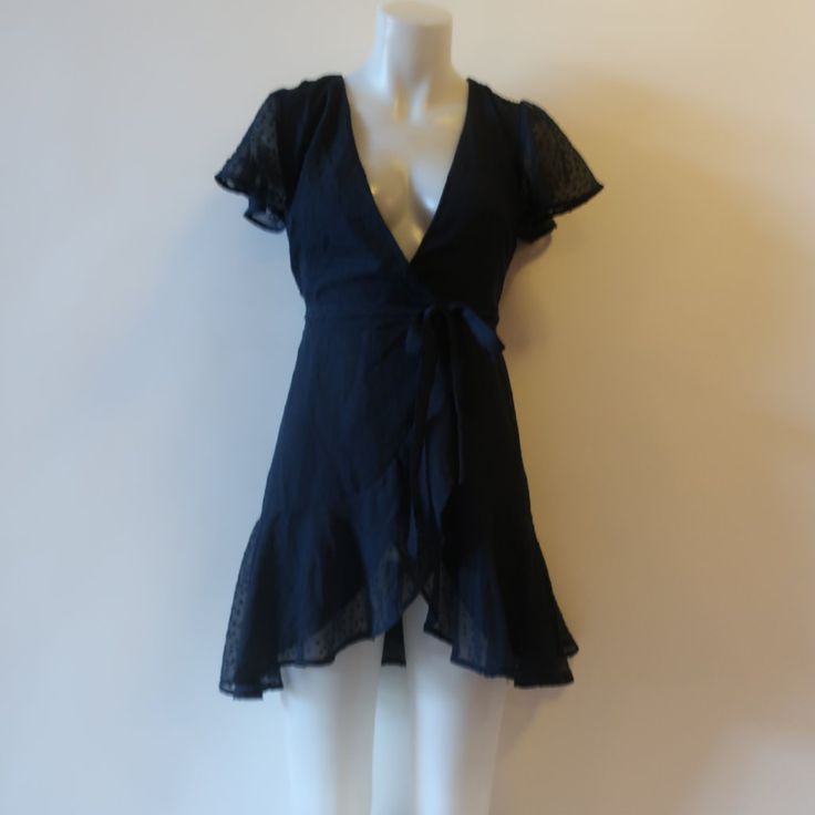 Nwt Womens Miami Francesca's Aviana Navy Blue Wrap Mini Dress Xxs * Ticketed Price: $48- Color: Navy Blue Size: Xx-Small Monochromatic Texture Dotted Pattern Wrap Waist Tie Closure Semi Sheer Short Flutter Sleeve Ruffled Hemline Lined Material: 100% Polyester Measurements (Flat): Shoulders 13" Armpit: 15" Waist: 11" Hips: 14.5" Sleeve: 6" Length: 34.5" Nwt, New With Tags. ...Ws_hmptn2263 -4** Navy Mini Dress For Summer, Ruffled Wrap Dress For Night Out, Fitted Mini Wrap Dress For Night Out, Fitted Flirty Wrap Dress With Ruffles, Navy Knee-length Mini Dress For Summer, Navy Short Sleeve Mini Dress For Summer, Blue Mini Wrap Dress For Spring, Navy Fitted Mini Dress For Night Out, Fitted V-neck Wrap Dress For Casual Wear