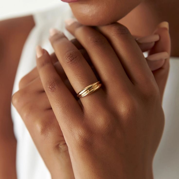 a close up of a person wearing a gold ring