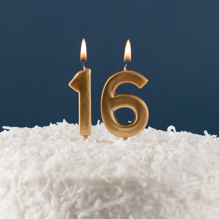 a close up of a cake with candles in the shape of number 16 on it