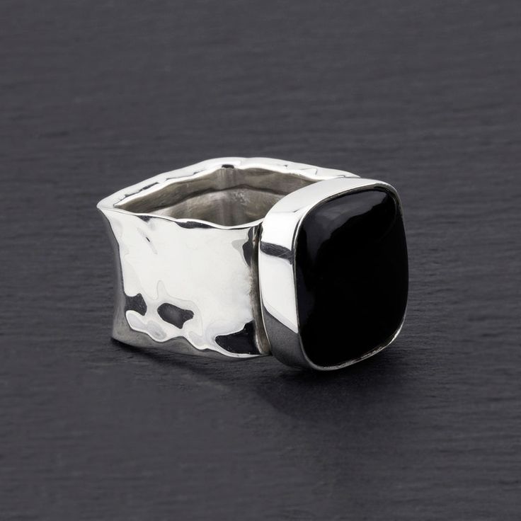 Make a bold statement with this square band black obsidian ring. The sleek and substantial design of this ring highlights the allure of the black obsidian square, adding a touch of mystery and elegance. With its thick hammered silver band, this ring is both modern and timeless. Elevate your style with the dramatic presence of this piece, perfect for those who appreciate a confident and distinctive look.  See a matching necklace. Gemstone - Black Obsidian 925 Sterling silver Hammered finish The s Black Obsidian Ring, Chunky Silver Rings, Obsidian Ring, Obsidian Stone, Jewelry Design Inspiration, Square Rings, Necklace Gemstone, Black Obsidian, Silver Band Ring