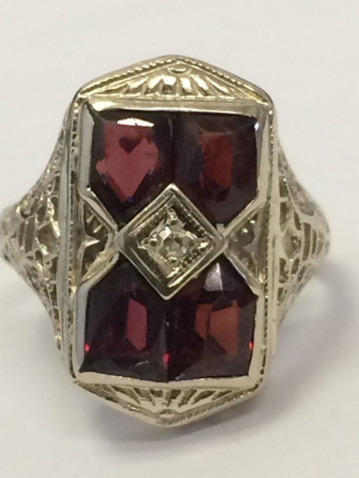 "VINTAGE 14K WHITE GOLD ANTIQUE GARNET ART DECO COCKTAIL RING BEAUTY!! Size 5.25 Each garnet measures approximately 5mm x 4mm Ring face measures 3/4\" high x 6/16\" wide. 3.6 grams One of the garnets are scratched across (see pics). Not cracked through. Shipped insured/delivery confirmation I guarantee item to be exactly as described and pictured." Antique Signet Ring With 17 Jewels For Formal Occasions, Estate White Gold Diamond Cut Rings, Antique Signet Ring With 17 Jewels For Anniversary, Art Deco Collectible 14k White Gold Rings, Collectible Art Deco 14k White Gold Ring, Estate White Gold Oval Rings, Estate Style Oval White Gold Rings, Antique Embellished Signet Ring For Formal Occasions, Vintage Round Birthstone Ring For Formal Occasions