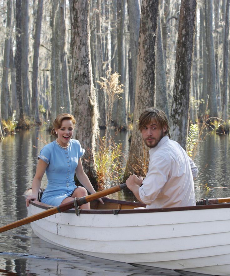 a man and woman are in a boat on the water