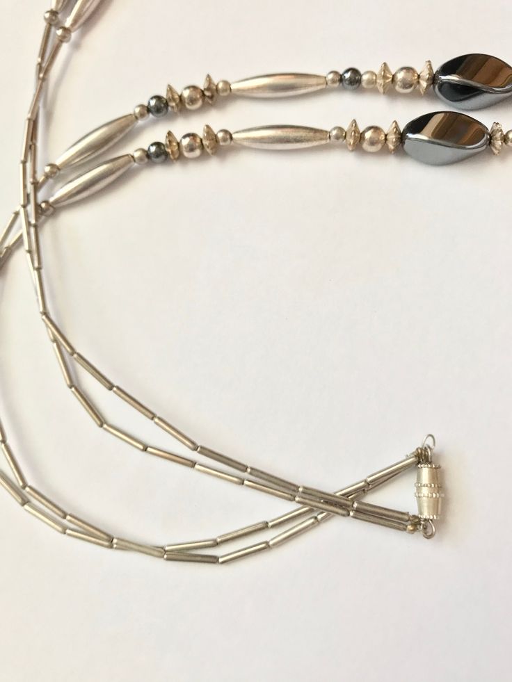 "This is a stunning vintage 1970s Native American Navajo sterling silver and hematite necklace. The necklace has two strands. The longest strand measures 30 inches the shortest strand measures 26\" The decorative hematite bead area in the front measures 3 1/2 inches and is 1 1/4\" long. It has a screw closure. There is some providence with this piece. A letter to the recipients was still with the item from the estate. It explains how she Came about purchasing the necklace as a gift. There is als Vintage Silver Multi-strand Beaded Necklace, Vintage Silver Multi-strand Jewelry, Classic Silver Multi-strand Necklace, Bohemian Silver Jewelry With Hematite, Silver Southwestern Long Necklace, Silver Double Strand Necklace With Sterling Clasp, Vintage Silver Double Strand Jewelry, Adjustable Vintage Beaded Necklace In Silver, Vintage Silver Adjustable Beaded Necklace