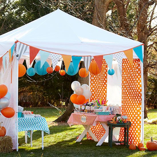 an outdoor party tent with balloons and decorations