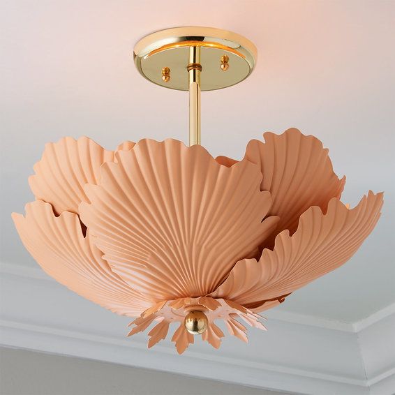 a pink ceiling light hanging from the ceiling in a room with white walls and ceilings