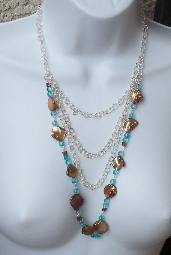 Multi Strand Shell Necklace Bronze Shells Blue Glass Beads Pearl Necklace With Round Beads For Gift, Pearl Necklace With Chain As Gift, Beaded Metal Layered Necklace As Gift, Blue Bohemian Pearl Necklace For Gift, Elegant Turquoise Long Necklace For Gift, Beaded Metal Long Necklace For Gift, Blue Adjustable Layered Necklace As Gift, Adjustable Blue Layered Necklace Gift, Silver Beaded Layered Necklace As Gift