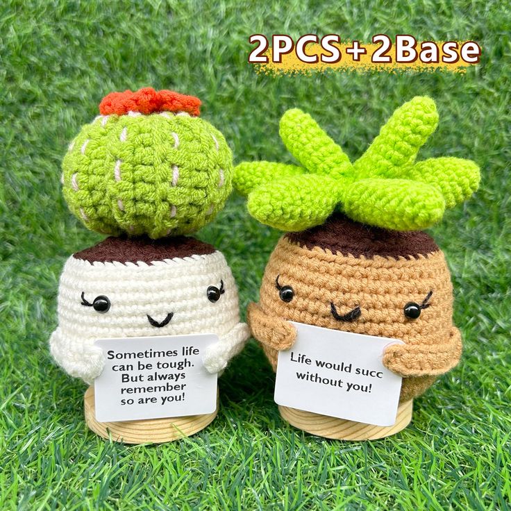 two small crocheted pots with plants on top of them, one holding a sign