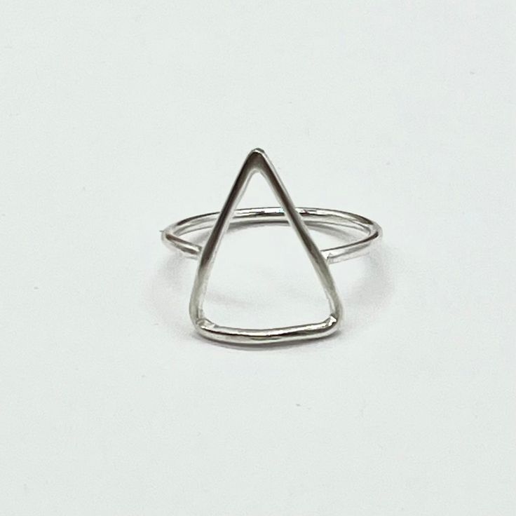 Add some edge to your outfit with our Morgan Triangle ring. Available in all Silver or mixed metal with Gold filled wire. A unique and playful piece that mixes metals for a modern twist. Embrace the triangle and let your style shine with this quirky ring. Featuring a unique Morgan triangle design and mixed metals, this ring is sure to make a statement. Versatile and stylish, it goes with everything! Everyday Triangle Nickel-free Jewelry, Everyday Nickel-free Triangle Jewelry, Silver Triangle Jewelry For Everyday, Hand Forged Minimalist Metal Rings, Minimalist Hand Forged Metal Rings, Silver Triangle Metal Jewelry, Adjustable Triangle Jewelry For Everyday, Sterling Silver Triangle Rings As Gift, Sterling Silver Triangle Rings For Gifts