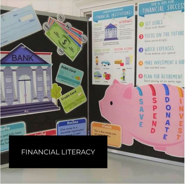 a pink piggy bank sitting on top of a table next to a blackboard