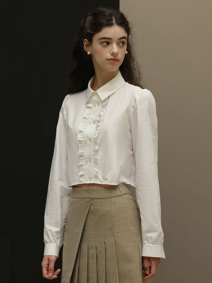 Editor's NotesDUNDROP displays timeless and classic styles with feminine details- Feminine blouse- Cropped length- Ruffled detail at the placket- Double buttonsMeasurements(in.)Size: S / M- Length: 16.9 in. / 17.3 in.- Bust: 39.8 in. / 41.3 in.- Shoulder: 14.6 in. / 14.9 in.- Sleeve: 24.4 in. / 24.8 in.* Model info: height 5' 7, Fitting size SComposition & Care- 100% cotton- Hand wash or dry cleaningDesigner- by DUNDROP Elegant Ruffled Button-up Shirt, Timeless Spring Collared Blouse, Formal Ruffled Collared Shirt, Elegant Collared Shirt With Ruffles, Timeless Button-up Spring Blouse, Spring Timeless Button-up Blouse, Timeless Spring Button-up Blouse, Formal Ruffled Button-up Shirt, Elegant Workwear Shirt With Ruffled Collar