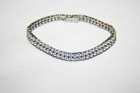 Vintage sterling silver bracelet with clear cubic zirconia. Hallmarked on inside.  In good condition with minor wear commensurate to age. See photos for measurements. Formal Sterling Silver Sparkling Diamond Bracelet, Formal Sparkling Diamond Bracelet In Sterling Silver, Formal Sparkling Sterling Silver Diamond Bracelet, Classic Silver Crystal Bracelet, Elegant Iced Out Sterling Silver Bracelet With Cubic Zirconia, Elegant Iced Out Sterling Silver Bracelet, Iced Out Sterling Silver Elegant Bracelet, Classic Silver Crystal Diamond Bracelet, Classic Silver Sparkling Diamond Bracelet