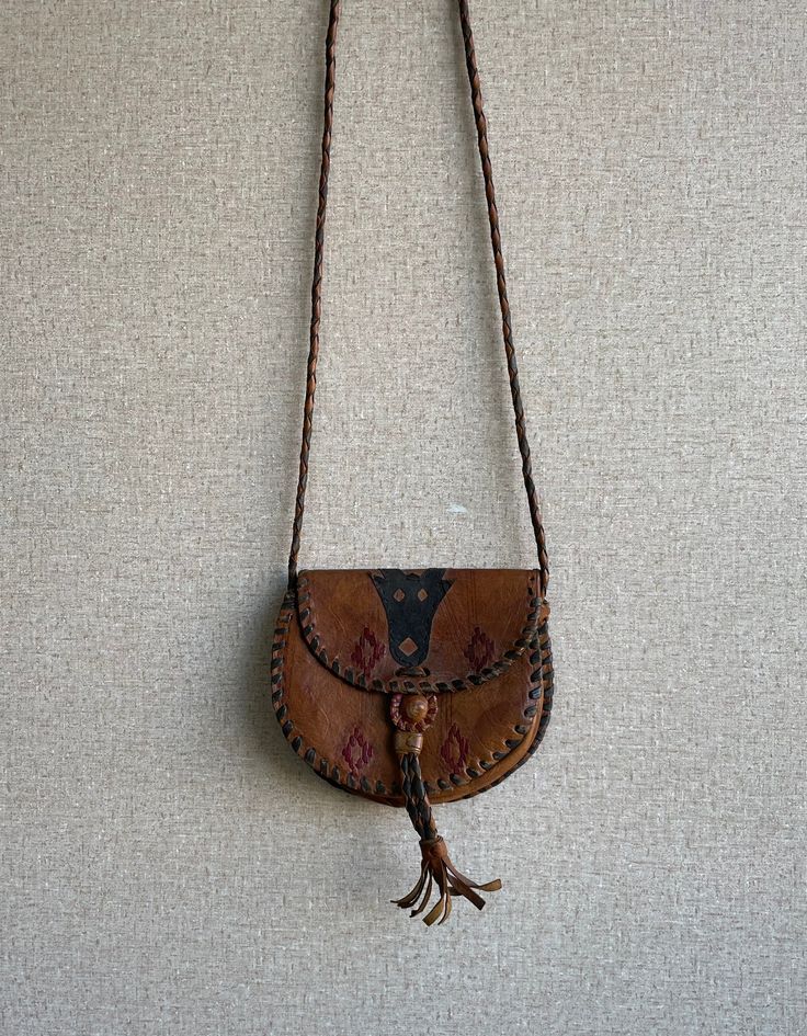 Add a unique touch to your wardrobe with this beautiful Tuareg Leather Shoulder Bag. Handcrafted from genuine African leather and featuring a vintage design, it will make a timeless addition to your collection. Full Length / Long: 25” Brown Artisan Shoulder Bag For Festivals, Bohemian Leather Saddle Bag With Leather Handles, Handmade Bohemian Leather Saddle Bag, Bohemian Crossbody Shoulder Bag With Leather Lining, Bohemian Leather Shoulder Bag With Hand-stitched Details, Leather Bohemian Saddle Bag For Daily Use, Bohemian Leather Saddle Bag For Daily Use, Bohemian Brown Hand-tooled Shoulder Bag, Bohemian Leather Saddle Satchel Bag