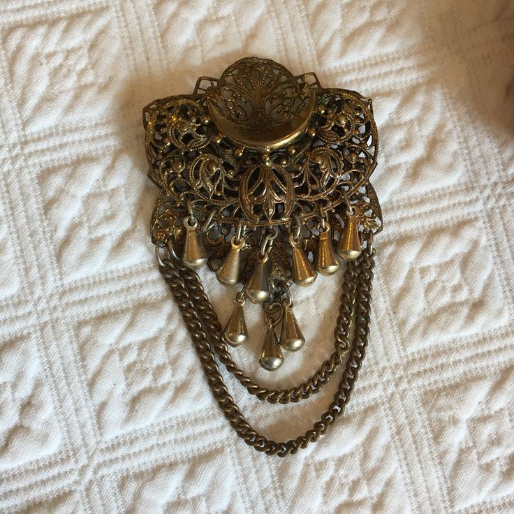 "Vintage Victorian Filigree Pin with Hanging Chains and Dangles in Gold Tone. Great for Victorian Reenacting and Costuming. This pin is in good shape. It is missing one of the gold dangling pieces, but this is not too noticeable. Size: 1 7/8\" X 3 1/8\" For other vintage items see:  www.VeryVictorianStudio.etsy.com. For sewing related items see my other shop: www.SewingRoomStore.etsy.com. Thank you for looking!" Victorian Filigree, Noah S Ark, Snowflake Ornaments, Vintage Victorian, Brooch Pin, Brooches, Gift Tags, Vintage Items, Gold Tones