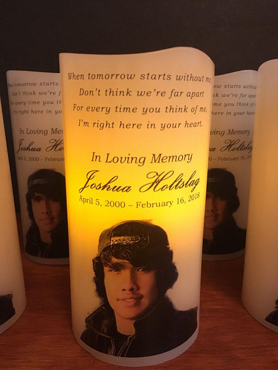 candles with pictures on them sitting next to each other in front of a candle holder