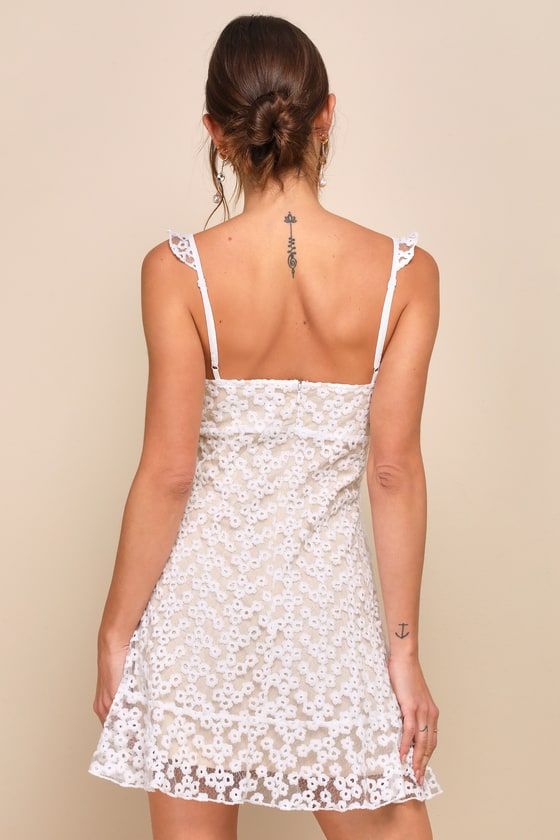 The Lulus Charmaine White Embroidered Mini Dress is sweet and simply divine! This femme little frock is formed from sheer mesh (atop a nude knit liner) embellished with ditsy floral embroidery. Ruffle trim accents the adjustable straps and tying keyhole neckline, while seamed cups meet with an empire waist. The figure flaunting silhouette ends at a ruffle-trimmed mini hem. Hidden back zipper/clasp. Fit: This garment fits true to size. Length: Above mid-thigh. Size medium measures 33" from top to Mini Length Delicate Lace Dress For Brunch, Delicate Mini Lace Dress For Brunch, Feminine Fitted Mini Dress With Delicate Lace, Floral Embroidered Mini Dress For Garden Party, Party Dress With Delicate Lace Mini Length, Flirty Delicate Lace Summer Dress, Garden Party Floral Embroidered Mini Dress, Spring Lace Trim Mini Dress, Flirty Spring Mini Dress With Lace Trim