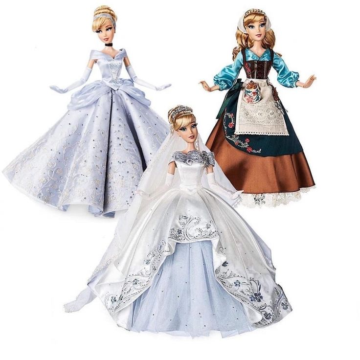 two barbie dolls in wedding dresses and tiaras, one is wearing a blue dress