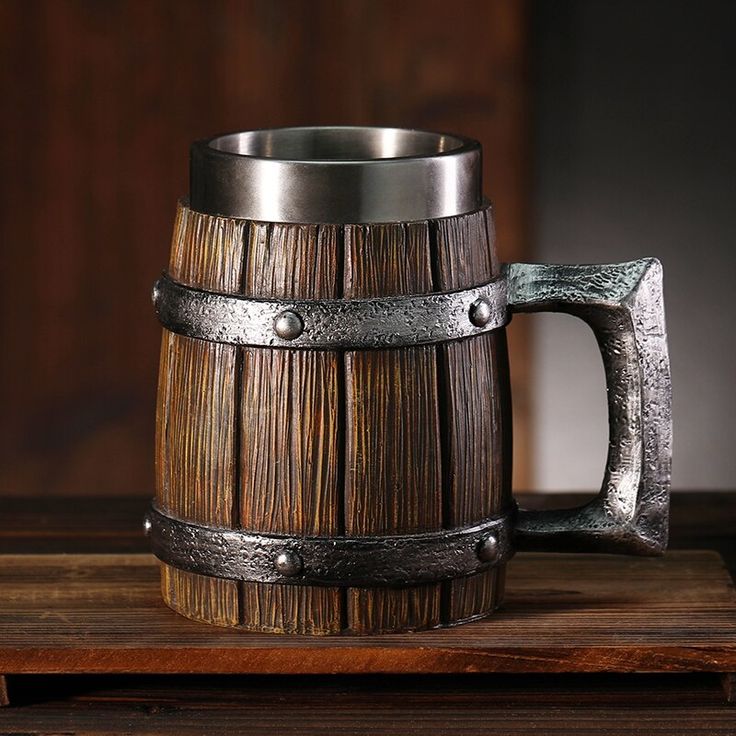 a wooden barrel with metal handles on a table