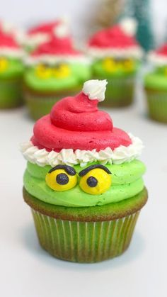 cupcakes with green frosting and red decorations