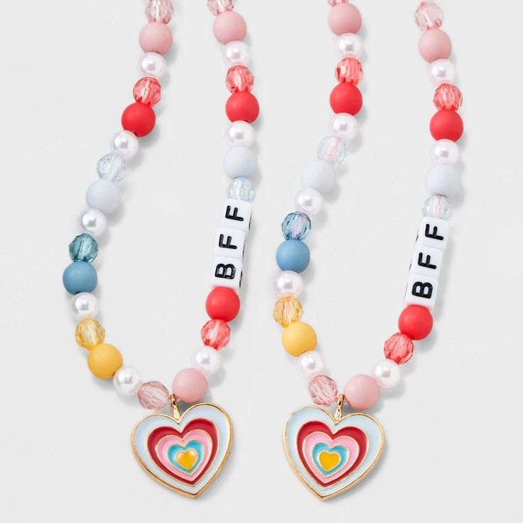 The Girls' 2pk Heart Charms BFF Necklace Set from Cat & Jack™ includes two charming necklaces with heart-shaped pendants, perfect for sharing with your best friend. With an overall length of 16 inches and a lobster claw clasp closure, these necklaces are easy to wear and secure. Made with quality zinc alloy, polyester and acrylic, these necklaces are not only stylish but also durable. Get these adorable "BFF" beads and show off your friendship in style. Cat & Jack™: Kids’ clothing with an imagin Playful Pink Charm Necklace For Friendship, Playful Pink Charm Necklaces For Friendship, Adjustable Cute Charm Necklaces For Friendship, Trendy Pink Charm Necklace For Friendship, Cute Adjustable Charm Necklace For Friendship, Cute Adjustable Charm Necklaces For Friendship, Personalized Playful Necklace For Friendship, Cute Adjustable Heart Charm Necklace, Cute Adjustable Necklace With Heart Charm