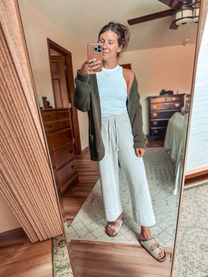 grey wide-leg sweatpants outfit, white tank top style, green cardigan fashion, gold jewelry accessories, taupe suede Birkenstock sandals, casual loungewear look, relaxed weekend wear, comfy yet chic, effortless athleisure style, cozy fall outfit, neutral tone fashion, elevated casual wear, stylish loungewear, versatile cardigan outfit, laid-back casual chic, minimalist fashion inspiration, comfy and stylish, casual layering ideas, relaxed yet stylish, transitional season outfit ideas. Cute Casual Weekend Outfits, Yoga Outfit Summer, Comfy Outfits For Home Lazy Days, Rehab Outfit, Fall Loungewear Outfits, Dressed Up Sweatpants Outfit, Style Yoga Pants Outfits, Styling Grey Sweatpants, Grey Wide Leg Sweatpants Outfit