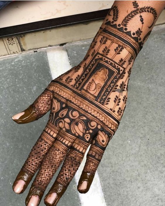 the hand is decorated with intricate designs