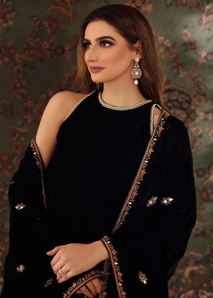 Black velvet halter neck shirt handworked with resham, dabka, tilla and zardozi on the neckline, sleeves and at the back. Paired with black flared pants. Can be paired with black velvet Shawl all handworked with resham, dabka, zardozi and mirrorwork details Velvet Indian Outfits, Halter Neck Shirt, Black Velvet Shawl, Black Pakistani Suit, Multi Dupatta, Velvet Suit Design, Black Velvet Suit, Neck Patterns, Neck Lines