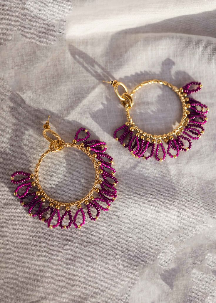 Beautiful, chic golden hoop style earrings that have purple pearl and golden pearls and mini-loop detailing. These earrings are curated with high-quality stainless steel material. Modern Purple Jewelry For Party, Modern Purple Metal Jewelry, Purple Metal Drop Earrings, Trendy Gold Beaded Earrings With Dangling Beads, Trendy Small Hoop Purple Jewelry, Trendy Purple Small Hoop Jewelry, Purple Metal Beaded Drop Earrings, Purple Dangle Hoop Earrings, Purple Small Hoop Earrings For Pierced Ears