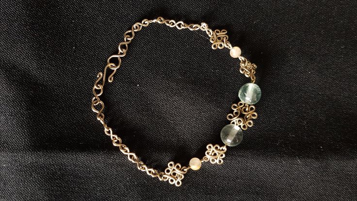 These unique  filigree bracelets are 100% handcrafted from alpaca (or nickel) silver wire. Approximate measurements: - Flourite (7mm) and gold rutilated quartz (3mm): 178- 185mm long - Garnet (4mm) and turquoise (3mm): 180- 203mm long - Lapis lazuli (5mm) and blue goldstone (3mm): 165- 211mm long - Black rutilated quartz (10mm) and pale rose quartz (5mm): 195- 215mm long These bracelets can be lengthened up to an inch at no charge. Elegant Brass Bracelets For Jewelry Making, Elegant Gold Agate Crystal Bracelet, Elegant Brass Bracelets With Filigree, Elegant Brass Bracelet With Filigree Detail, Handmade Brass Bracelets In Silver, Elegant Brass Bracelets With Filigree Details, Nickel-free Elegant Charm Bracelet With Round Beads, Elegant Brass Filigree Bracelets, Silver Brass Spiritual Bracelets