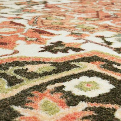 an area rug with many different colors and designs on it's surface, including green, orange, red, white and black