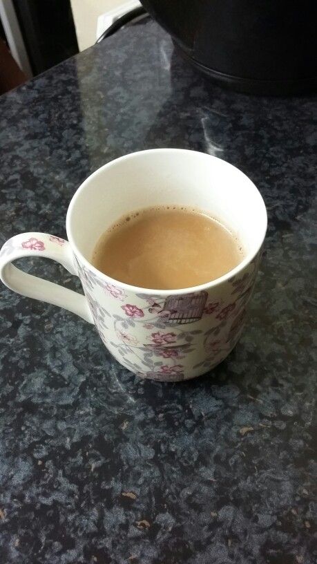 a cup of coffee sitting on top of a counter