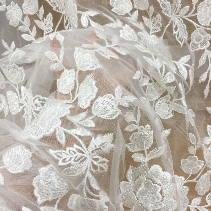 white lace fabric with flowers and leaves on it