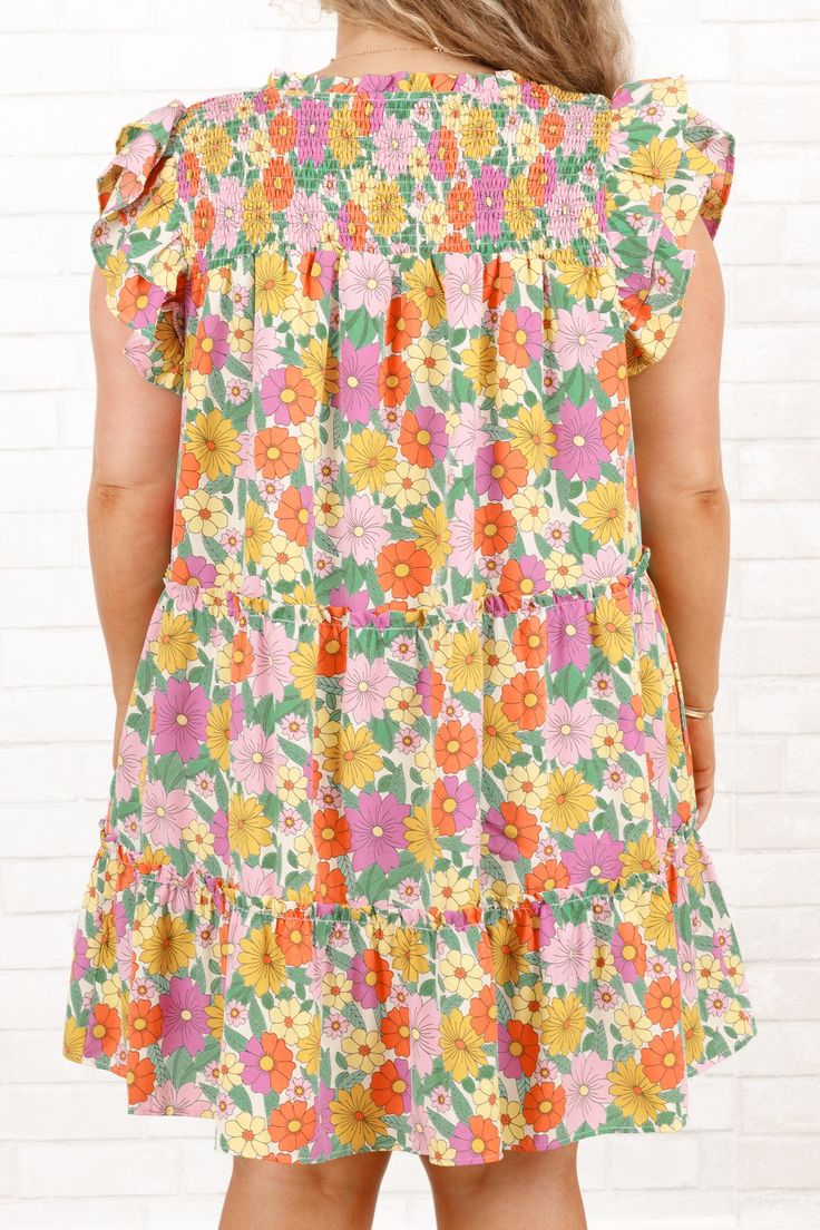 Look graceful and romantic in this beautiful dress! Its flutter sleeves and floral pattern create a perfect blend of comfort and style, making it ideal for casual outings! Its flirty length shows off your curves for a look that is sure to turn heads! 100% Polyester Flowy Ditsy Floral Print Dress With Ruffle Sleeves, Flowy Dress With Ditsy Floral Print And Ruffle Sleeves, Multicolor Floral Dress With Ruffles And Short Sleeves, Multicolor Short-sleeve Floral Dress With Ruffles, Multicolor Flutter Sleeve Dress With Ruffle Hem, Multicolor Flowy Ruffle Sleeve Dress, Multicolor Flowy Dress With Ruffle Sleeves, Casual Floral Dress With Short Sleeves And Ruffles, Spring Beach Sundress With Flutter Sleeves