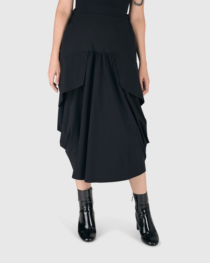 Tekbika Gotta Have It Skirt, Black – Alembika U.S. Black Long Draped Skirt For Work, Workwear Skirted Bottoms With Pleated Waist, Black Long Skirt With Side Pockets, High Waist Pleated Elastane Skirt, Tiered Skirt With Side Pockets, Workwear Draped Lined Flowy Skirt, Workwear Flowy Draped Lined Skirt, Flowy Draped Skirt For Workwear, Modern Midi Skirt For Workwear