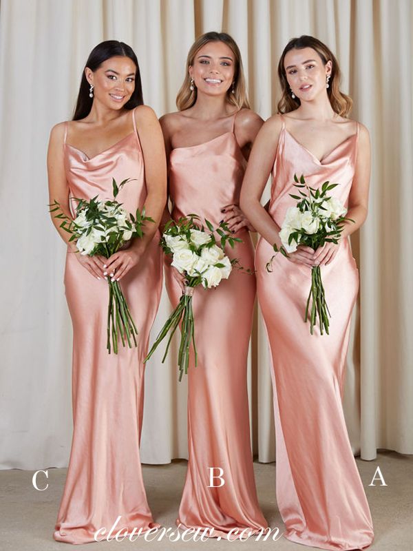 three bridesmaids in pink dresses posing for the camera with their bouquets and flowers